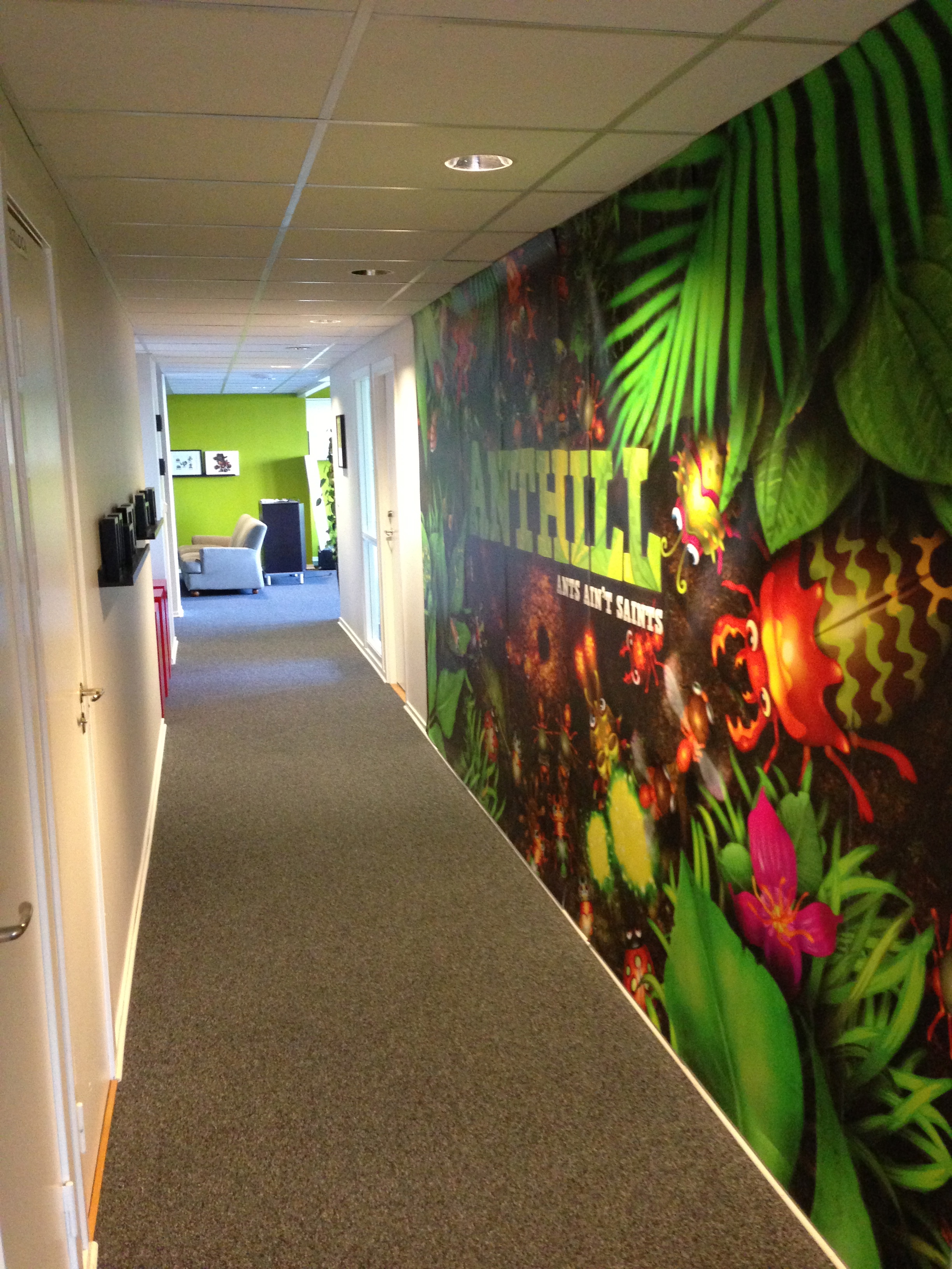This mural is the most ostentatious display in the office, and even that is hidden en route to the kitchen.
